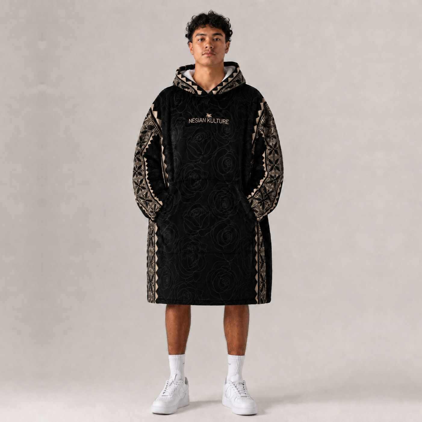 Nesian Kulture black and gold oversized snug hoodie, front view on male model