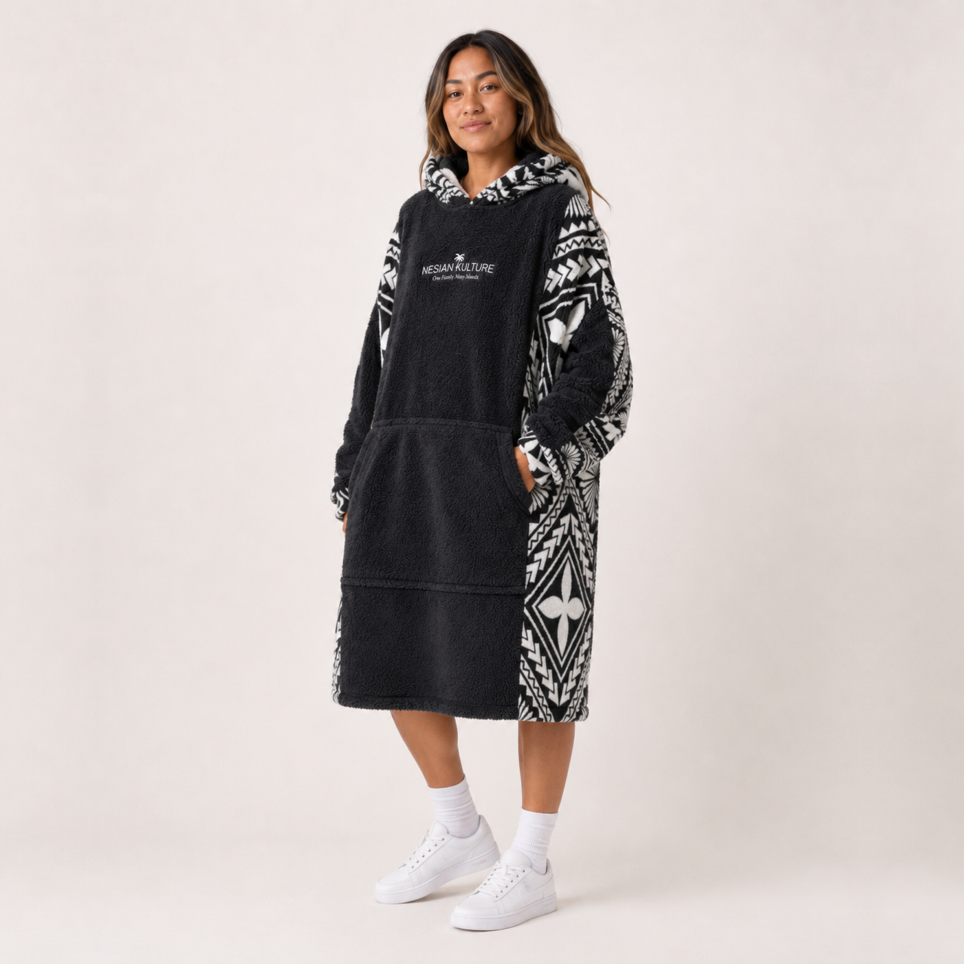 Nesian Kulture charcoal and white oversized snug hoodie, angled front view with patterned sleeves
