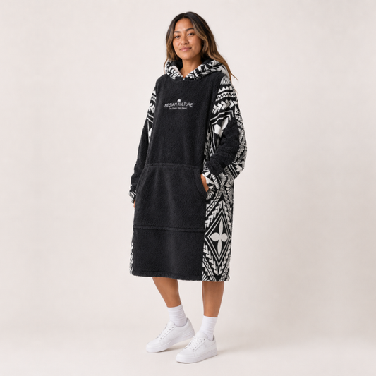 Nesian Kulture charcoal and white oversized snug hoodie, angled front view with patterned sleeves